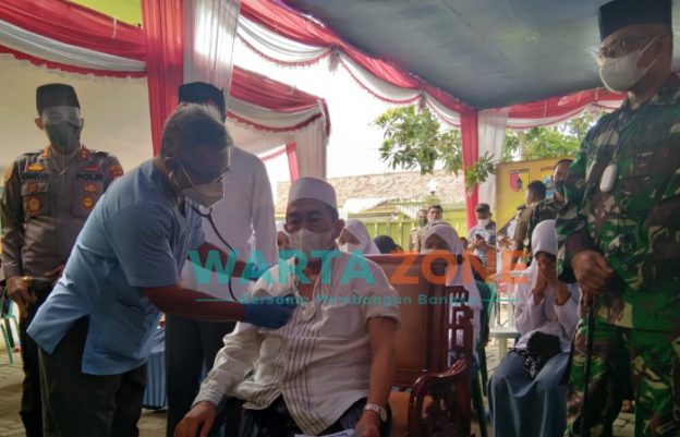 PATUT DICONTOH: Pengasuh Pondok Pesantren Attaufiqiyyah, KH. Imam Hasyim, saat divaksin di lingkungan pesantren (Dok. WARTA ZONE)