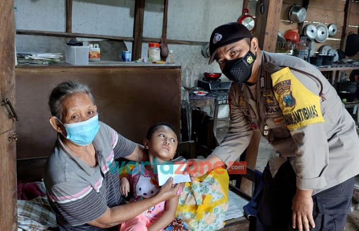 Foto: Bhabinkamtibmas Polsek Tulakan, Polres Pacitan, Polda Jawa Timur Bripka Latip Utomo, saat membantu warga penyandang disabilitas.