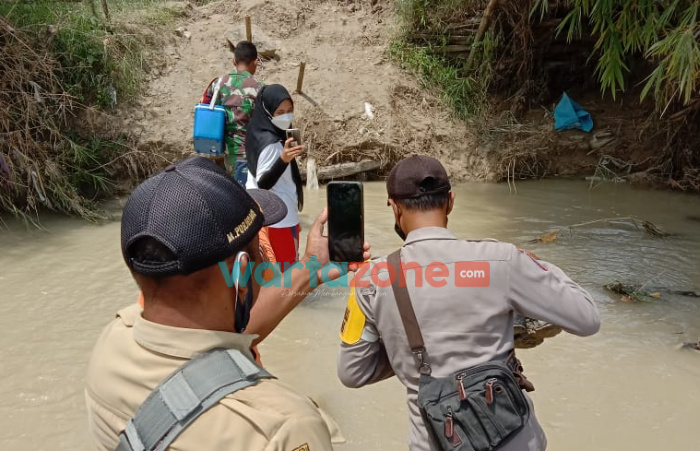 Foto: Bhabinkamtibmas Desa Ngrancang, Kabupaten Bojonegoro bersama Tiga Pilar Desa Ngrancang dan Nakes bahu membahu melakukan vaksinasi door to door mengarungi sungai.